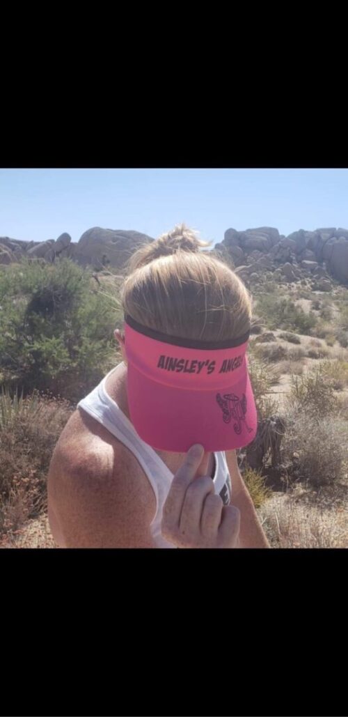 woman showing her Ainsley’s Angels of America visor hat