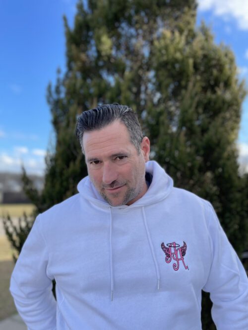A picture of a man wearing a white color sweatshirt