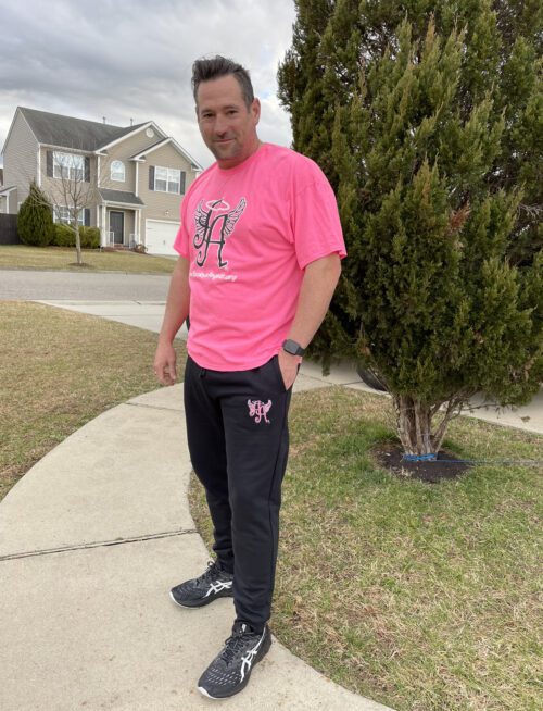 A picture of a man wearing a pink shirt