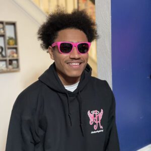 A picture of a man wearing pink eye glasses