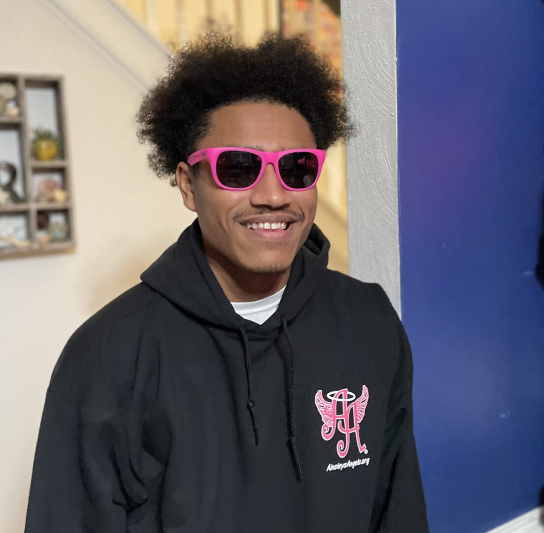A picture of a man wearing pink eye glasses
